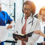 qualified medical examiner doctor surrounded by associates