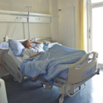 woman lying in hospital bed