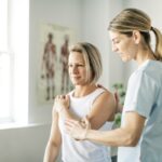 A Modern rehabilitation physiotherapy worker with woman client