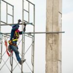 Construction worker working on scaffolding in construction site