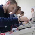 Group of young students in technical vocational training with teacher, the lesson in technical college. Education and technology concept.